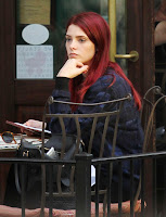 Ashley Greene sitting at a restaurant