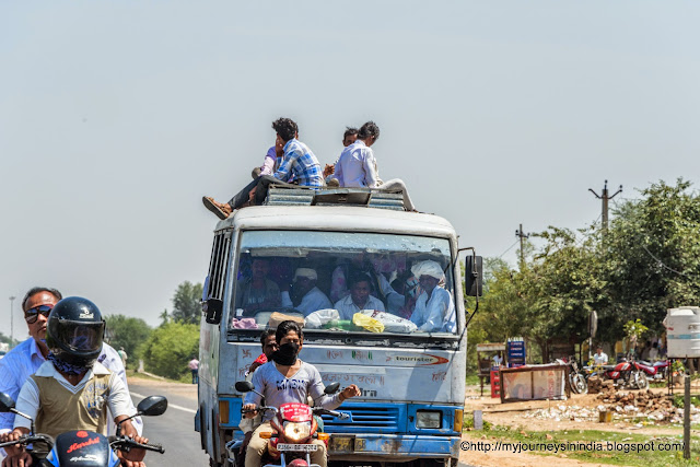 Passengers on roof of van