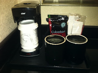 coffee cups and coffee maker on a counter