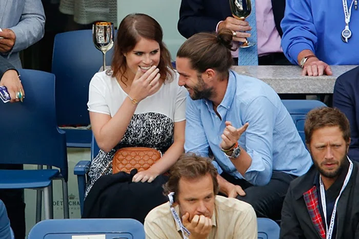 Tennis fan Princess Eugenie giggles as she watches the men's final with friend Phil Winser