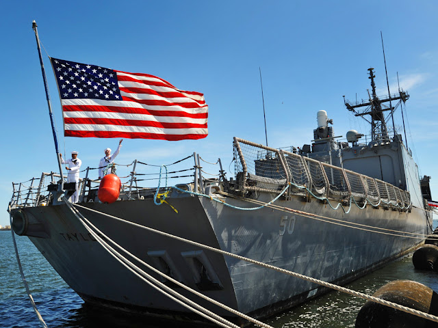 Petty Officer 3rd Class Jake Harris (left) and Petty Officer 2nd Class Mike Westfall lower the flag aboard the USS Taylor for the last time Friday during its decommissioning ceremony at Mayport Naval Station in Jacksonville - Photo: Will Dickey USS Taylor (FFG 50)