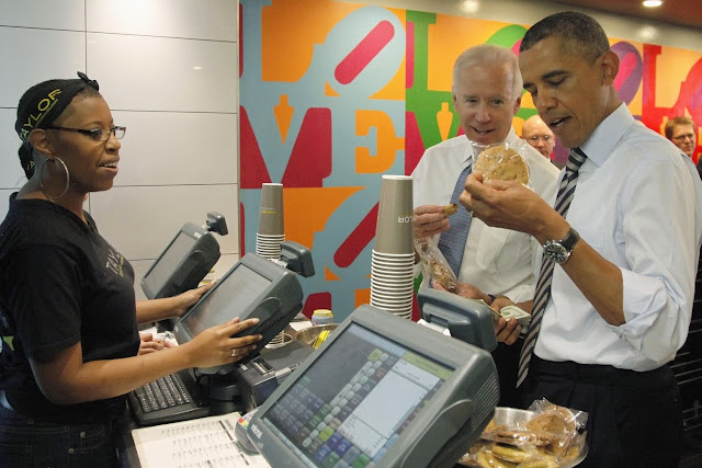 U.S. Vice President Joe Biden (C) helps President Barack Obama (R) pick out a pack of cookies as they buy lunch at a sandwich shop near the White House in Washington, October 4, 2013. House Republicans held their ground on Friday in a standoff with Obama over the U.S. government shutdown, accusing him of intransigence and not caring about the impact of the shutdown, now in its fourth day. REUTERS/Jonathan Ernst (UNITED STATES - POLITICS BUSINESS TPX IMAGES OF THE DAY- think IN pictures @1WORLDCommunity)