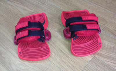A pair of red foot pads and straps