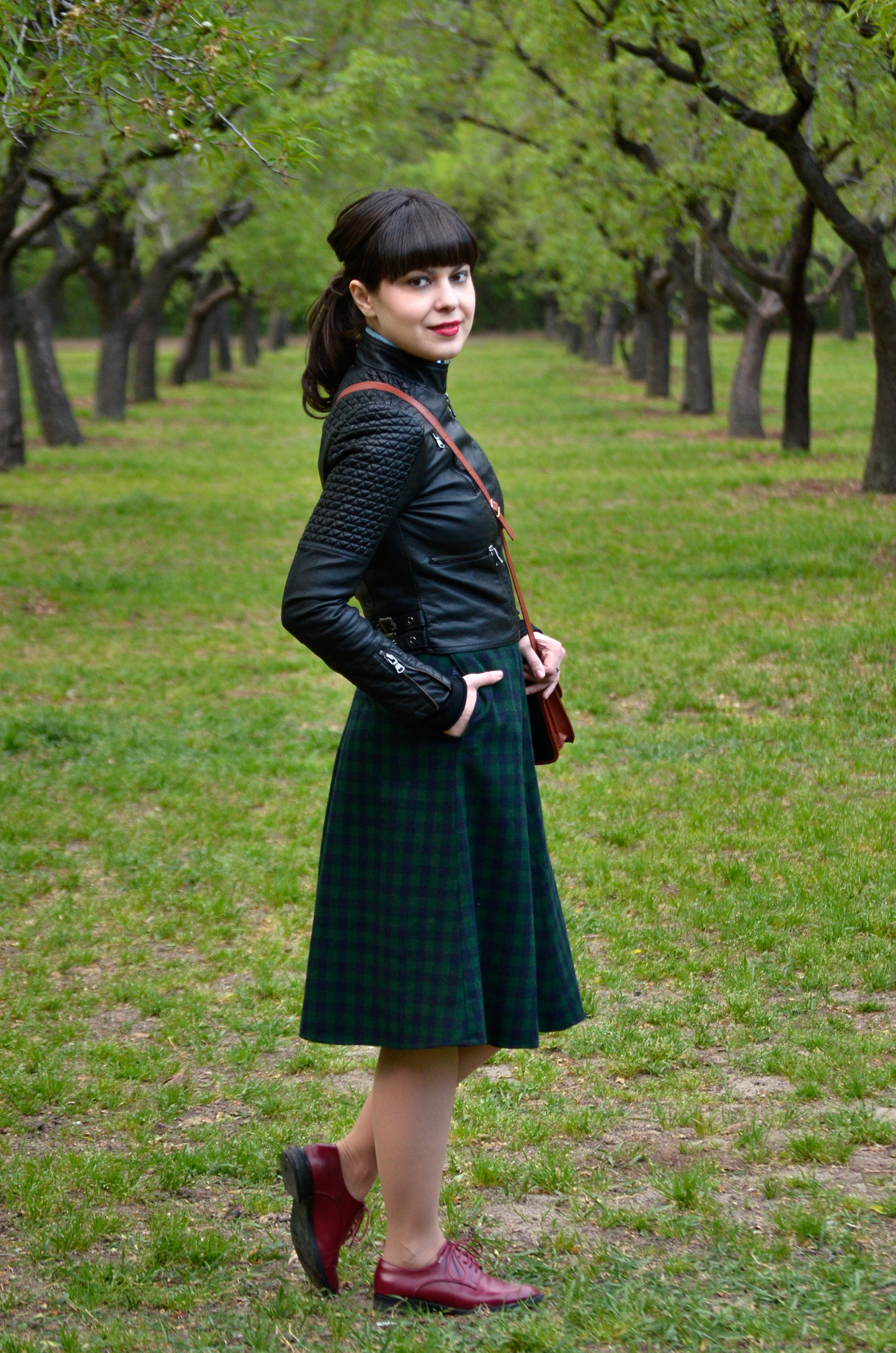 school girl outfit in madrid green tartan midi skirt thrifted brown bag satchel sky blue shirt black bow tie bangs burgundy oxford shoes poema spring green fresh park