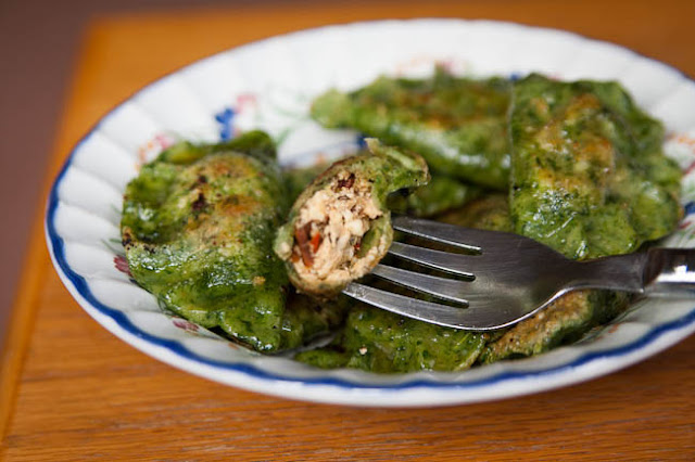 Green pierogi with curd cheese and dried tomatoes filling