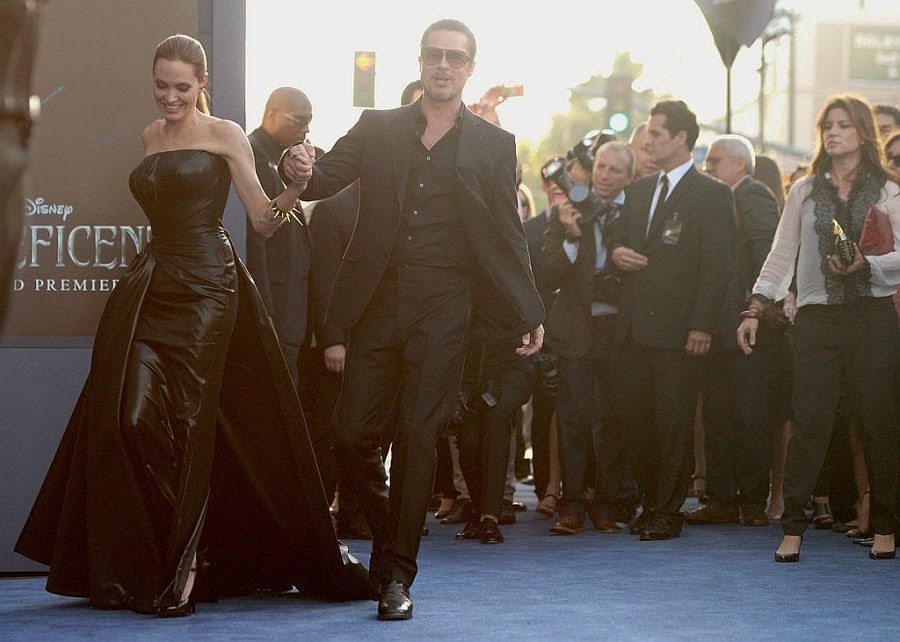Angelina Jolie and Brad Pitt are still engaged as they on a red carpet in Los Angeles Angelina Jolie was trying to apply her perfect fashion statement when she wore a beautiful black dress alongside her boyfriend Brad Pitt on Wednesday, May 28, 2014 at Los Angeles, USA.