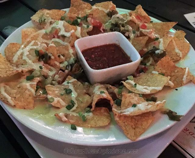 SCORE's killer nachos is a-must try. nachos score the roof first avenue