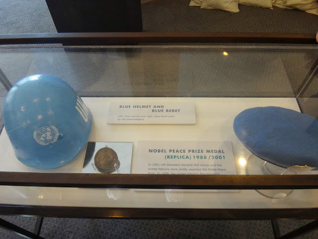 Blue helmet and Blue beret with replica of Nobel Peace Prize at United Nations Headquarter Building in New York, USA Blue helmet and Blue beret with replica of Nobel Peace Prize at United Nations Headquarter Building in New York, USA