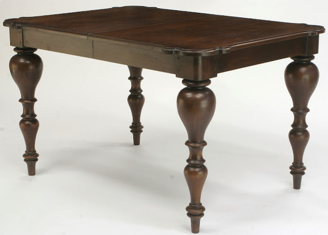 solid oak extension dining table with antique walnut finish has dramatic turned legs solid oak extension dining table with antique walnut finish has dramatic turned legs