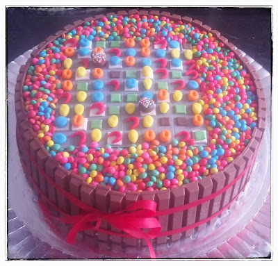 Candy Crush birthday cake decorated with M&M's, KitKat chocolate and fondant, white chocolate and strawberry filling.