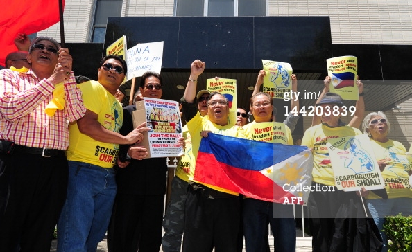 Filipinos protest in front of the Chinese Consulate in Los Angeles on May 11, 2012 in California, as part of a global protest over an escalating territorial row in the South China Sea. The territorial row centres on Scarborough Shoal, a tiny rocky outcrop in the South China Sea about 230 kilometres (140 miles) from the Philippines' main island of Luzon which the Philippines says is part of its territory because it falls within its exclusive economic zone. China, however, claims virtually all of the South China Sea, which is believed to sit atop huge oil and gas reserves, as its historical territory, even waters close to the coasts of other Asian countries. Editorials in newspapers controlled by the ruling Communist Party have repeatedly warned that China is prepared to go to war against the Philippines to end the stand-off. AFP PHOTO/Frederic J. BROWN (Photo credit should read FREDERIC J. BROWN/AFP/GettyImages)