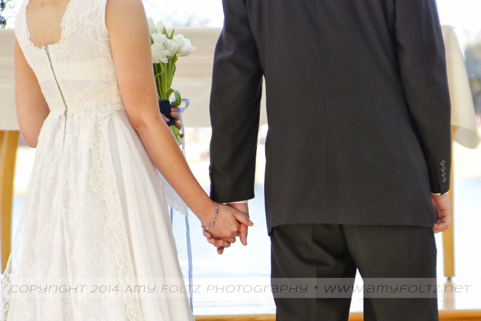 photo of a couple holding hands during wedding ceremony
