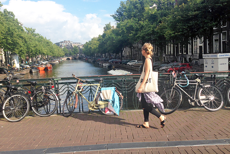 Double bun hair do, walking along the Canal in Amsterdam, Four Star Clothing plaid shirt, H&M cork slides, Suburban Riot canvas tote