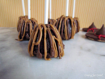 brownie bites with sticks decorated to look like witches brooms