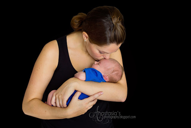 1 week old baby boy studio portrait with his mom