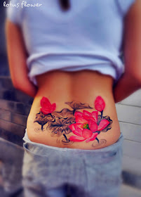 pink lotus flower tattoo on the lower back