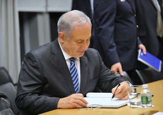 photo of Netanyahu signing