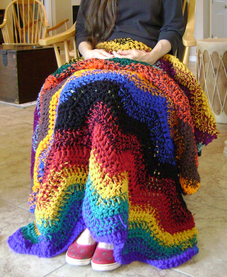 This generously sized lap-blanket is crocheted with a large hook and ...