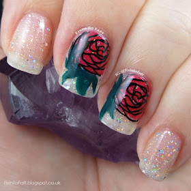 Romantic and sparkly nail art featuring roses and diamond glitter.