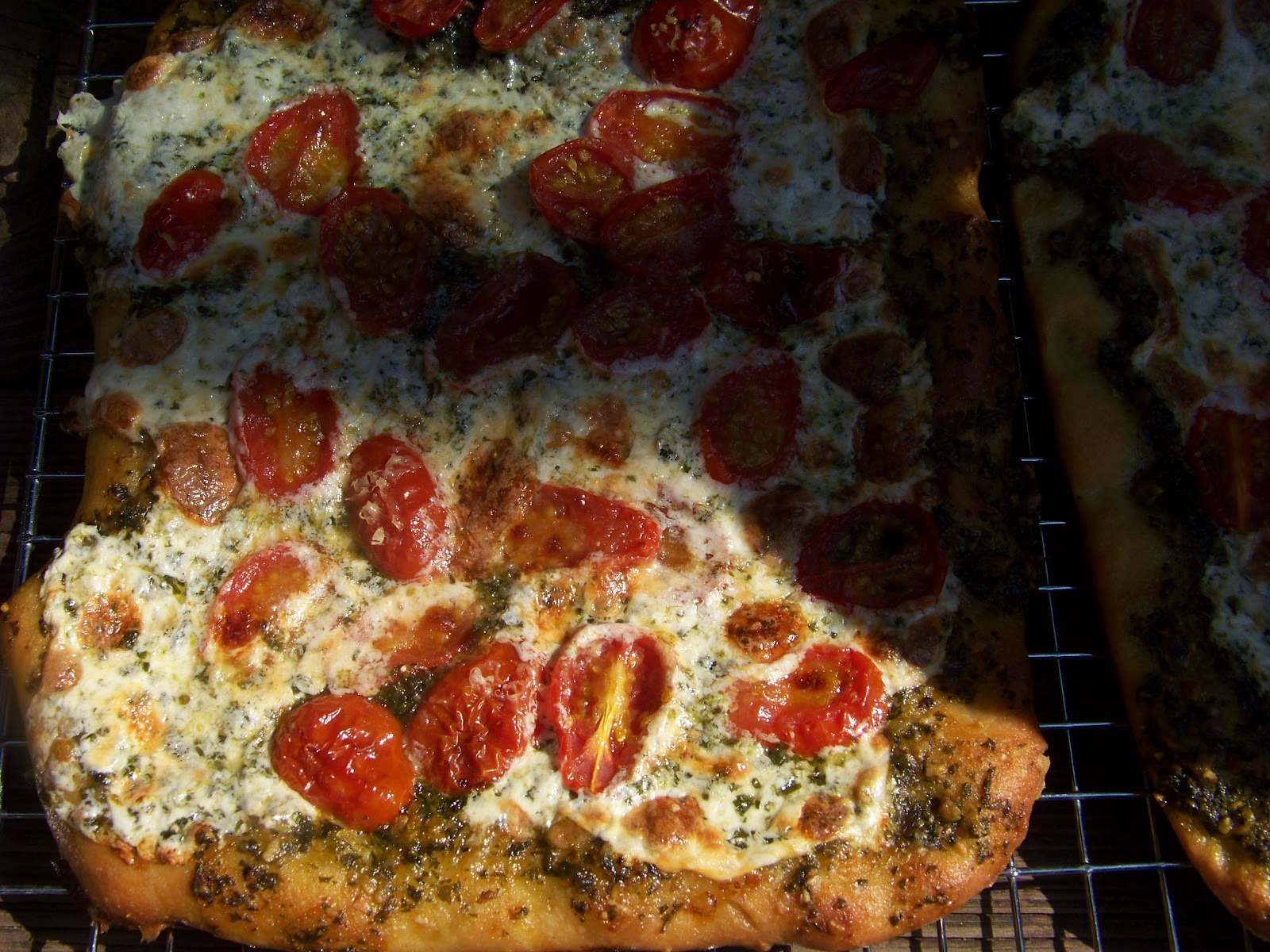Tora's real food Pesto, mozzarella, and cherry tomato pizzas