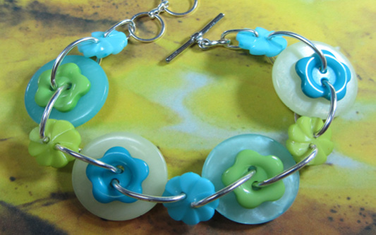 Rhapsody Flower Bracelet Teal and green bracelet has cute big buttons and flower linked together
