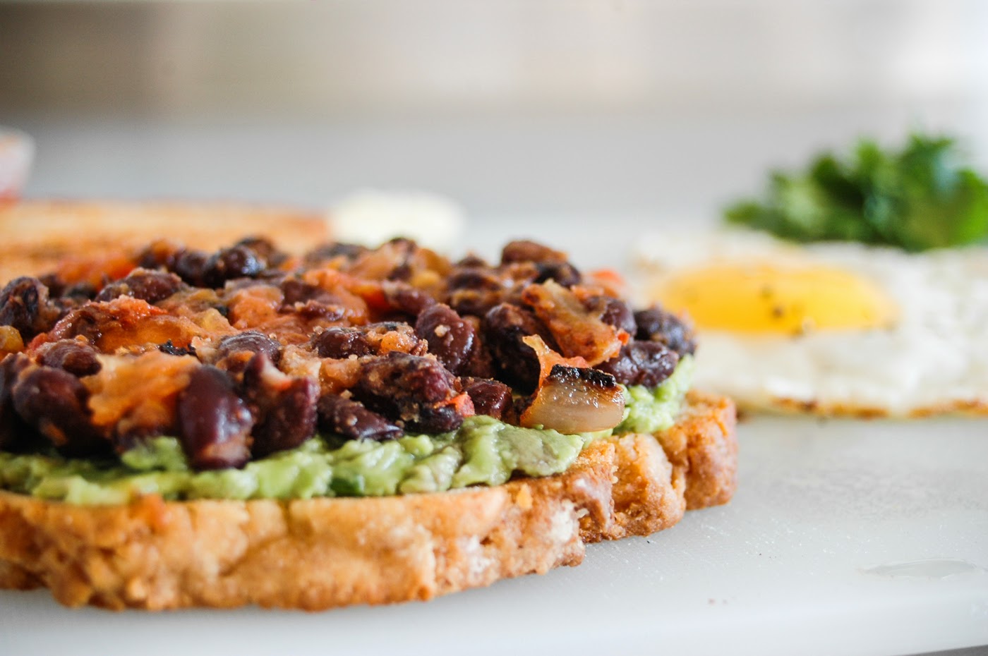 GLORIOUS SANDWICHES GRINGO chilli + black bean + guac + bacon + egg