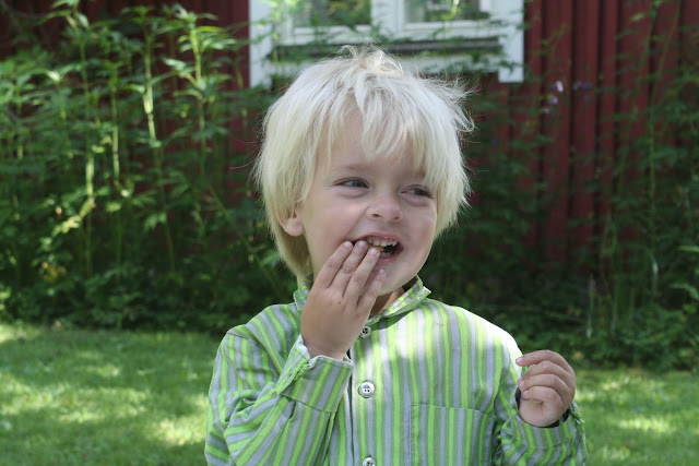 Anton eating Moomin buscuits in Finland.