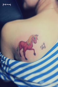 A red pony tattoo on the back