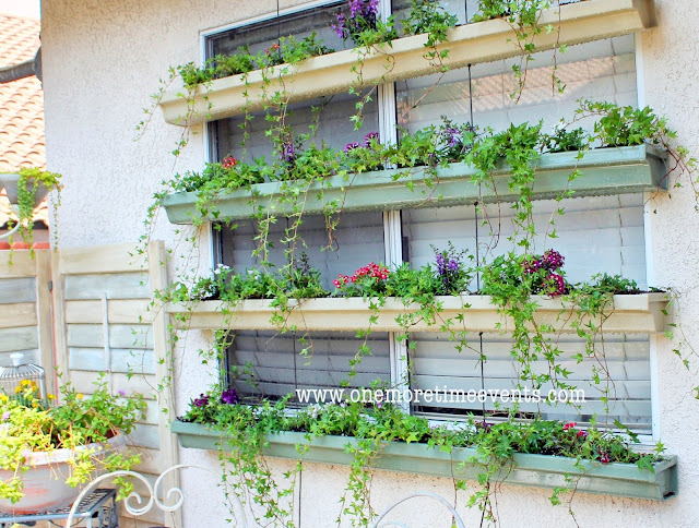 Rain gutter planter boxes to cool off hot windows. How creative! By One More Time Events featured on I Love That Junk