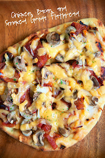 Chicken, Bacon & Smoked Gouda Flatbread Recipe - great way to use up leftover chicken. We sliced up the leftover chicken, added some bacon, mushrooms, smoked gouda and a drizzle of honey. AMAZING and super quick!