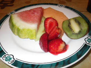 Desert plate with a selection of melons,strawberries and kiwi fruit.
