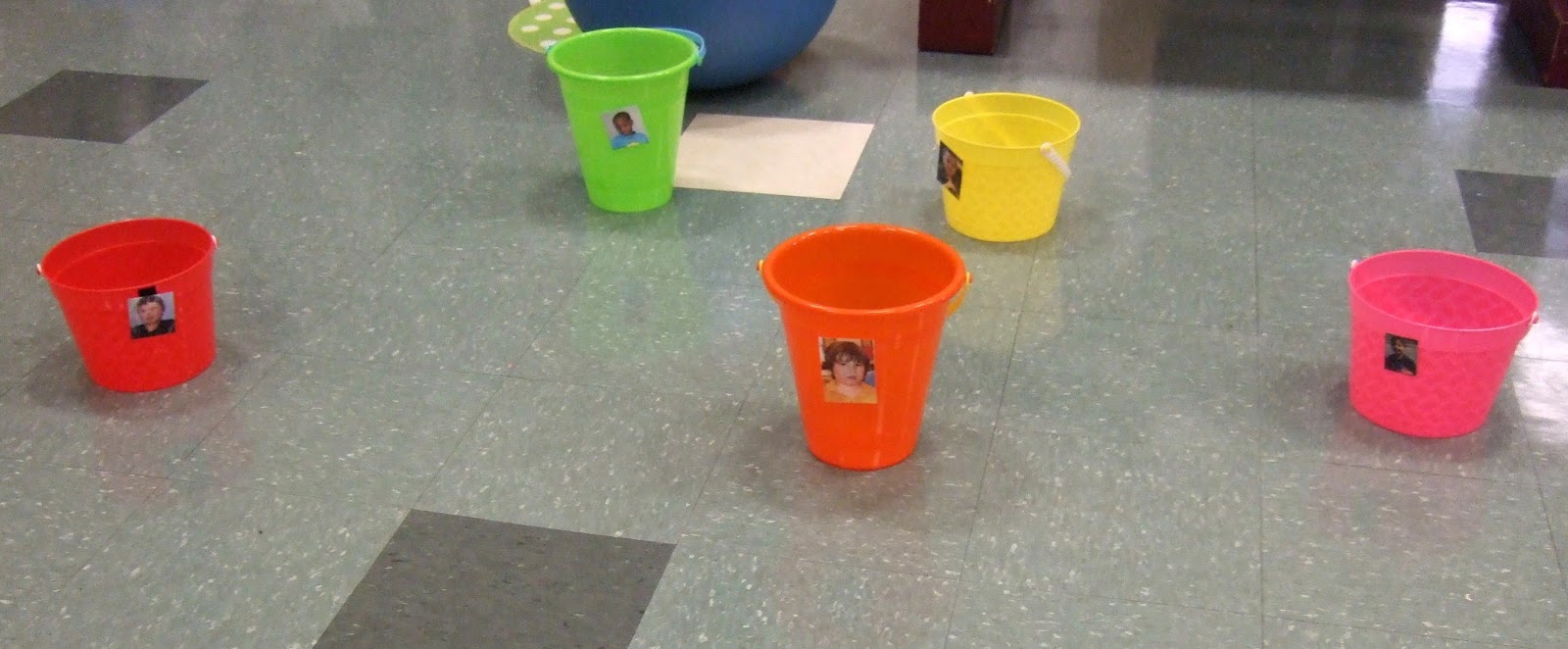 Buckets With Kids Pictures Are Spread Out On The Floor Player Whose Turn It Is Will Stand Behind A Line And Try To Toss Bean Bag Into One Of Buckets With Kids Pictures Are Spread Out On The Floor Player Whose Turn It Is Will Stand Behind A Line And Try To Toss Bean Bag Into One Of