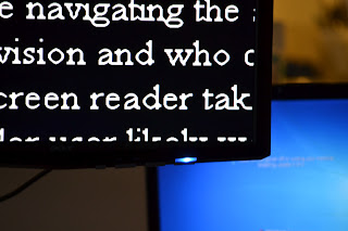 Close up of the corner of a computer monitor displaying large, high contrast print