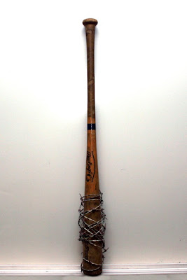 Baseball bat with nails or barbed wire
