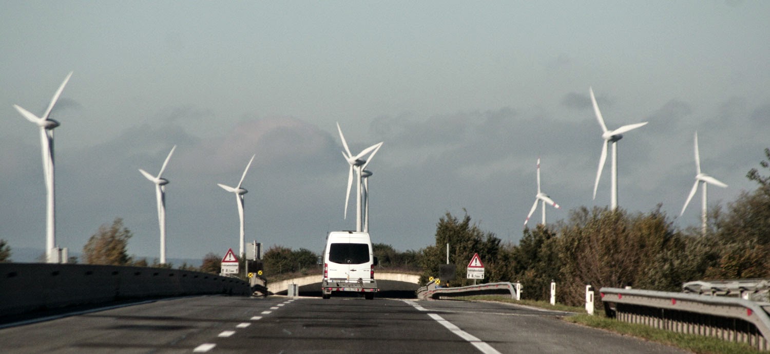 Huge wind turbines as the road goes under and eco bridge Huge wind turbines as the road goes under and eco bridge
