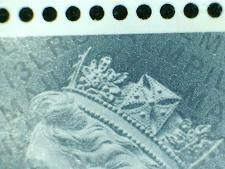 Close up of 5p Machin stamp showing security codes.