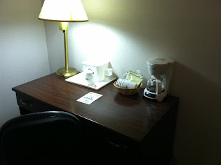 a desk with a lamp and a basket of food on it