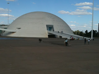 a large white dome building with people walking on stairs