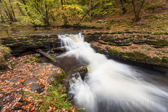 A small waterfall in the Brecon Beacons with autumn leaves by Martyn Ferry Photography