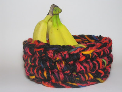Jumbo crochet basket using four strands of super chunky yarn and a huge crochet hook