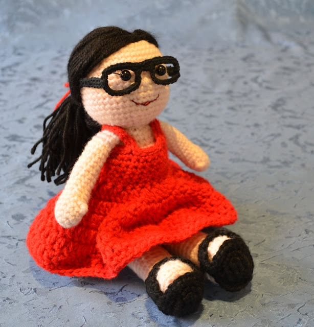 Kwokkie Doll in her very first outfit –a red summer dress with black sandals, black glasses and a red ribbon to tie her long black straight hair into a low ponytail.