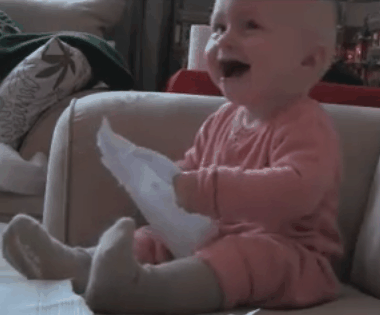 baby laughs at ripping paper baby laughs at ripping paper