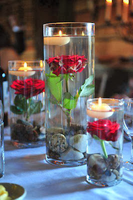 diyas on red rose in glass