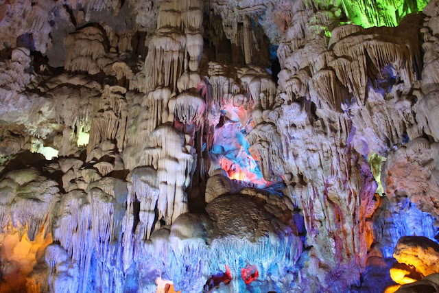 Blue lights flashing on the limestones through the stalactites and stalagmite at Thien Cung Grotto at Halong Bay in Hanoi, Vietnam Blue lights flashing on the limestones through the stalactites and stalagmite at Thien Cung Grotto at Halong Bay in Hanoi, Vietnam