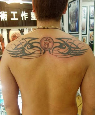 totem and sanskrit tattoo design on the back