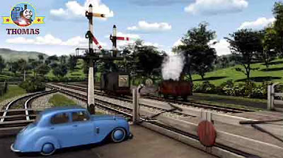The Fat Controller arrived at the railway crossing gates opposite Diesel Percy the green locomotive