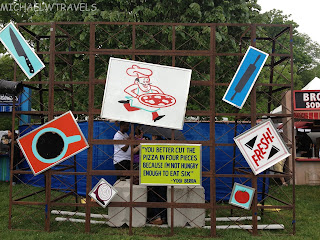a man standing behind a fence with signs
