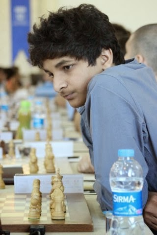 Visually impaired chess player Darpan Inani shows his opponents he