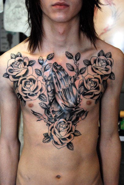a religion chest tattoo with roses 