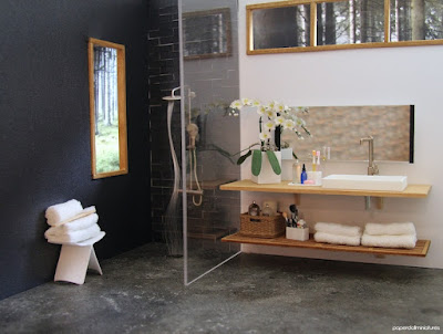 Modern dolls' house miniature bathroom with rain shower, butterfly stool stacked with towels and orchid plant on the sink unit.